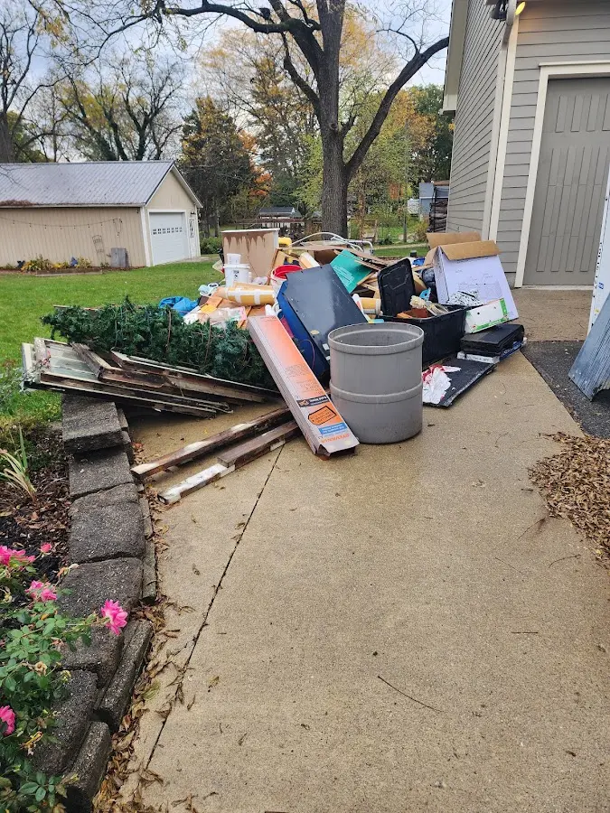 Dumpster being loaded with debris for 30 Yard Dumpster Rental in Baldwyn